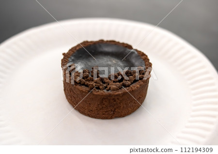 Round chocolate cookie on grey background closeup Round chocolate cookie on grey background closeup 112194309