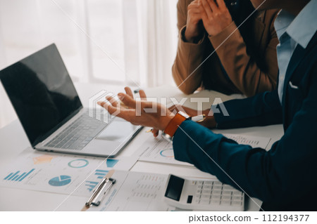 Business team working with new startup project plan and discussion information for financial strategy with laptop and digital tablet in a modern business lounge. 112194377