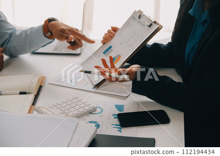 Business team working with new startup project plan and discussion information for financial strategy with laptop and digital tablet in a modern business lounge. 112194434