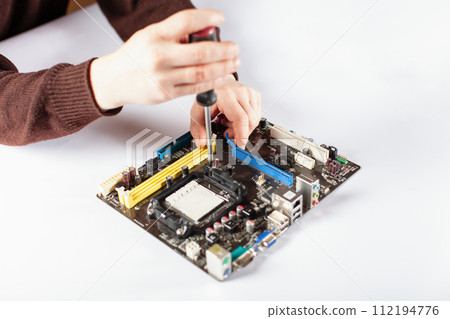 Technological background with closeup on tester checking motherboard. 112194776