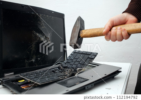 man destroyed laptop with a hammer. Nervous work, buggy computer, errors, slow Internet, not saved in the game, printed text, hung. Bad old computer failed, does not turn on, hangs. keyboard 112194792