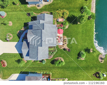 Aerial Top Down of Modern Waterfront Luxury Home with Lush Garden Aerial Top Down of Modern Waterfront Luxury Home with Lush Garden 112196160