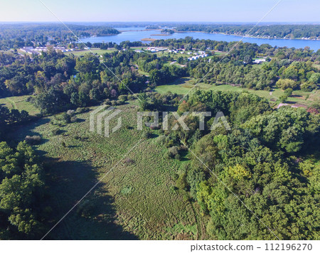 Aerial View of Serene Lakeside Community and Autumn Foliage 112196270