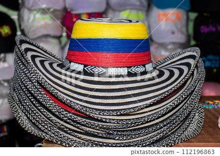 Sell of traditional hats from Colombia called sombrero vueltiao at the famous Comuna 13 in Medellin 112196863
