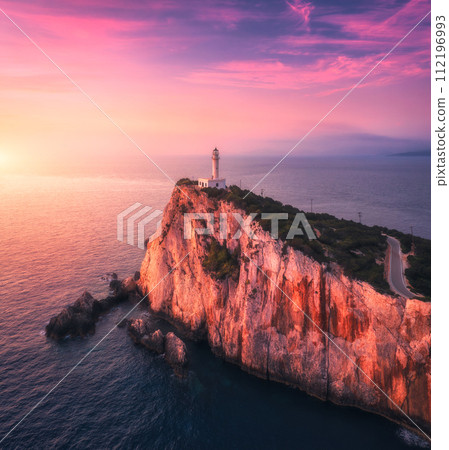 Lighthouse on the mountain peak at colorful sunset in summer 112196993