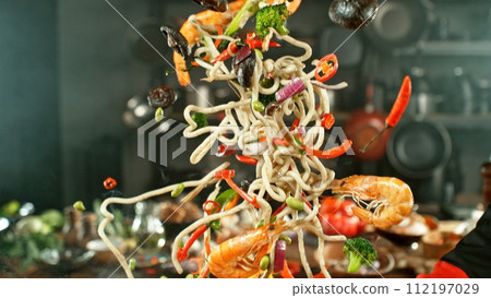 Freeze Motion of Wok Pan with Flying Asian Meal in the Air. 112197029
