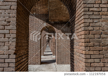 Endless brick passage with repeating archways in Fort Jefferson on Dry Tortugas National Park. 112197058