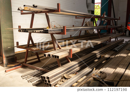 Metal profile pipe of rectangular cross section in packs at the warehouse of metal products. 112197198