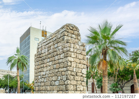 Stone ruins of old arab buildings with palms on the street of Al-Balad, Jeddah, Saudi Arabia 112197287