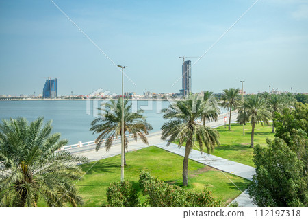 Dammam coastline corniche park with palms and developing city in the background, Saudi Arabia Dammam coastline corniche park with palms and developing city in the background, Saudi Arabia 112197318