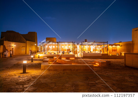 Old walls of Diriyah old town and modern arab restaraunt illuminated at night, Riyadh, Saudi Arabia Old walls of Diriyah old town and modern arab restaraunt illuminated at night, Riyadh, Saudi Arabia 112197357