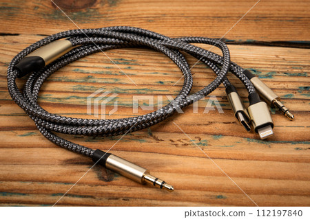 3 In 1 Type-C3.5mm Jack Aux Cable on a wooden texture background. Object 112197840