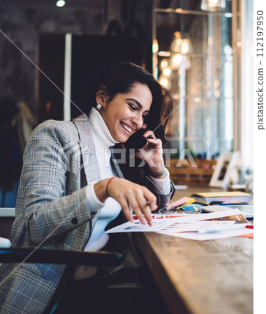 Cheerful remote worker calling on mobile creating project Cheerful remote worker calling on mobile creating project 112197950