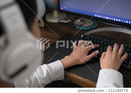Image of a boy or child playing online games on a computer Image of a boy or child playing online games on a computer 112198778