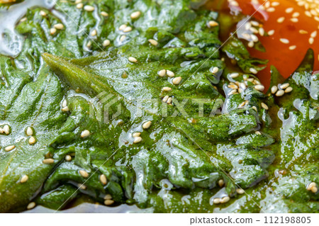 A close-up of shiso leaves pickled in soy sauce (with sesame seeds). 112198805