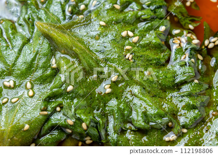 A close-up of shiso leaves pickled in soy sauce (with sesame seeds). 112198806