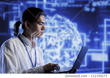 Qualified technician using laptop to maintenance artificial intelligence neural networks simulating human thought processes in computerized model. Admin doing checkup on AI systems 112199275