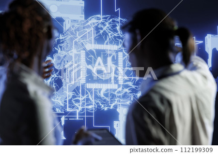 Tech support brainstorms ways to use AI cognitive computing to extract usable information from complex data. Server farm employees implement artificial intelligence to process inference datasets 112199309