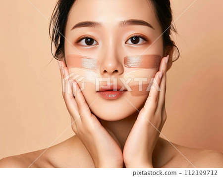 Asian woman applying foundation Asian woman applying foundation 112199712