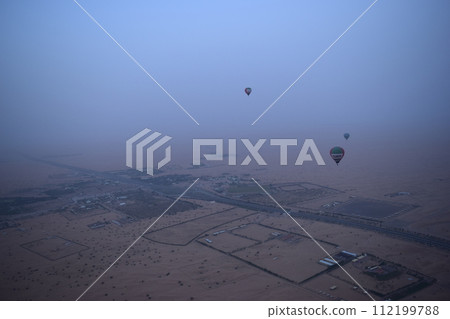 Desert hot air balloon in the morning fog Desert hot air balloon in the morning fog 112199788