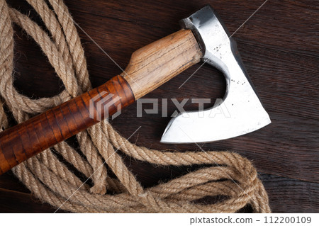 small axe with rope on wooden table 112200109