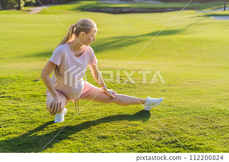 Energetic pregnant woman takes her workout outdoors, using an exercise mat for a refreshing and health-conscious outdoor exercise session Energetic pregnant woman takes her workout outdoors, using an exercise mat for a refreshing and health-conscious outdoor exercise session 112200824