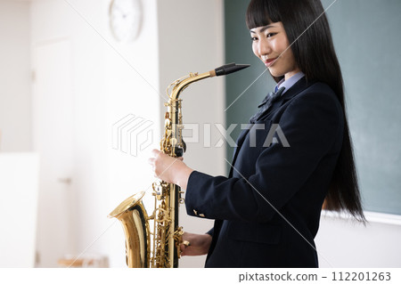 Student playing the saxophone, image of brass band and club activities Student playing the saxophone, image of brass band and club activities 112201263