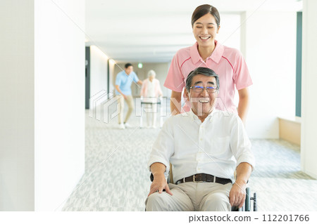 Senior in wheelchair and caregiver Senior in wheelchair and caregiver 112201766