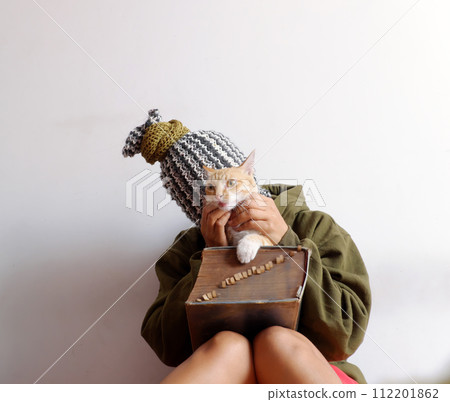 woman that head cover scarf, look like pineapple, hold cat in hand with old big book woman that head cover scarf, look like pineapple, hold cat in hand with old big book 112201862