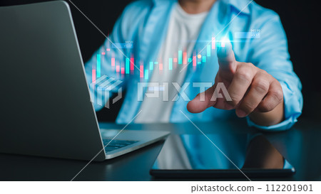 Close up of businessman hand pointing at candlestick chart on dark background. Financial crisis and recession concept, internet trading concept, business person touching chart by finger, Forex. 112201901