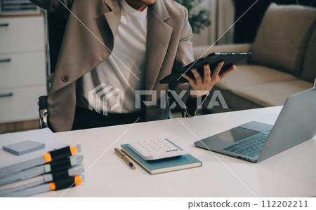 Business team working with new startup project plan and discussion information for financial strategy with laptop and digital tablet in a modern business lounge. 112202211