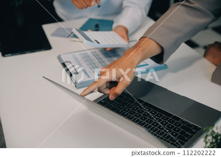 Business team working with new startup project plan and discussion information for financial strategy with laptop and digital tablet in a modern business lounge. 112202222