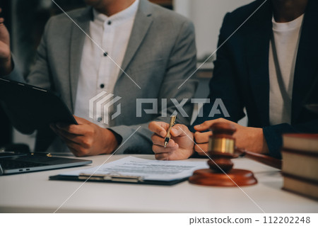 Consultation and conference of Male lawyers and professional businesswoman working and discussion having at law firm in office. Concepts of law, Judge gavel with scales of justice. 112202248