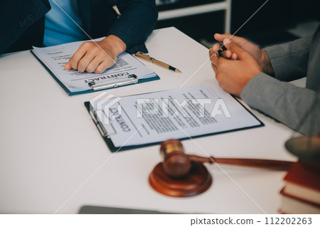 Consultation and conference of Male lawyers and professional businesswoman working and discussion having at law firm in office. Concepts of law, Judge gavel with scales of justice. 112202263
