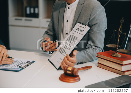 Consultation and conference of Male lawyers and professional businesswoman working and discussion having at law firm in office. Concepts of law, Judge gavel with scales of justice. 112202267