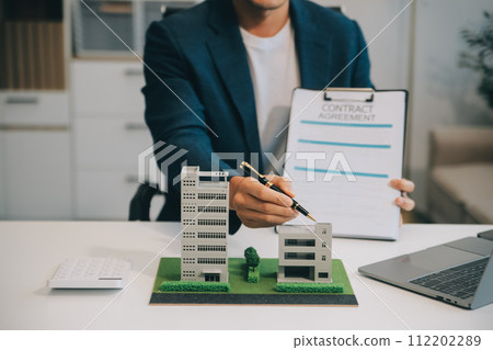 Real estate agent talked about the terms of the home purchase agreement and asked the customer to sign the documents to make the contract legally, Home sales and home insurance concept. 112202289