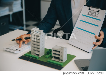Real estate agent talked about the terms of the home purchase agreement and asked the customer to sign the documents to make the contract legally, Home sales and home insurance concept. 112202290
