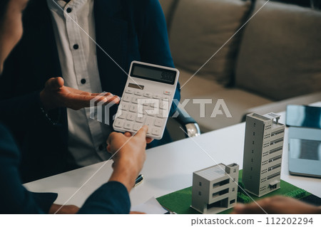 Real estate agent talked about the terms of the home purchase agreement and asked the customer to sign the documents to make the contract legally, Home sales and home insurance concept. 112202294