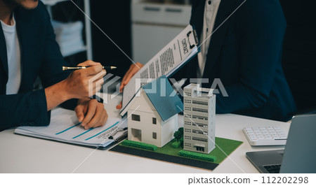 Real estate agent talked about the terms of the home purchase agreement and asked the customer to sign the documents to make the contract legally, Home sales and home insurance concept. 112202298