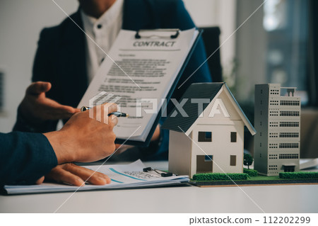 Real estate agent talked about the terms of the home purchase agreement and asked the customer to sign the documents to make the contract legally, Home sales and home insurance concept. 112202299