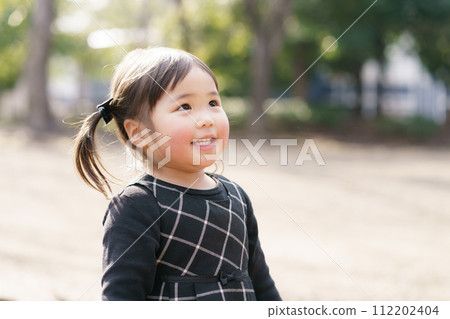 Little girl playing in the park 112202404