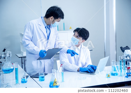 Two asian scientist team reserch chemistry science tube experiment biotech antibody sample in laboratory Cultivate Vaccine against covid-19 virus. Scientist consult, analyze in Chemistry Laboratory Two asian scientist team reserch chemistry science tube experiment biotech antibody sample in laboratory Cultivate Vaccine against covid-19 virus. Scientist consult, analyze in Chemistry Laboratory 112202460