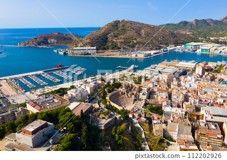 Aerial view of Cartagena port city with buildings and coast line, Murcia 112202926