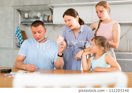 Spouses discuss unpleasant financial issue in kitchen, irritated wife takes money from husband Spouses discuss unpleasant financial issue in kitchen, irritated wife takes money from husband 112203148