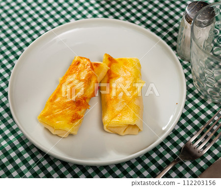 Polish savory crepes nalesniki with cream cheese, garlic and herbs Polish savory crepes nalesniki with cream cheese, garlic and herbs 112203156
