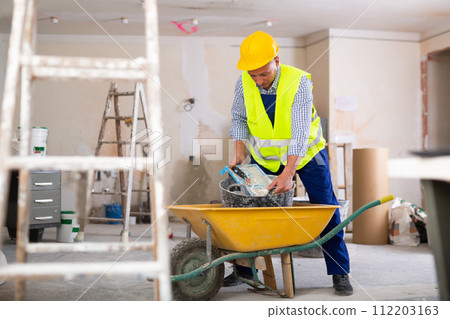Man builder working in construction site 112203163