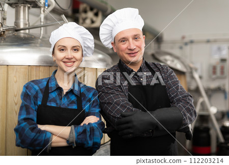 Man and woman - brewery owners with glasses of beer Man and woman - brewery owners with glasses of beer 112203214