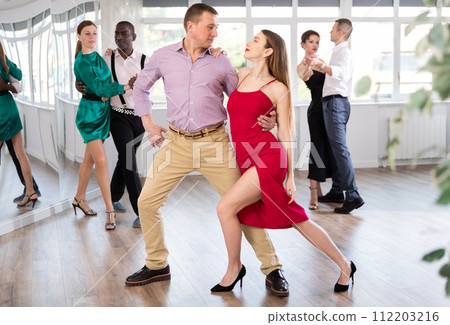 Man and young woman practicing waltz in dancing studio 112203216