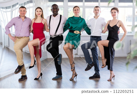 Group men and women of different nationalities dancing folk dance in row Group men and women of different nationalities dancing folk dance in row 112203251