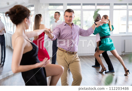 Woman dances incendiary boogie woogie with man partner during choreography lesson 112203486